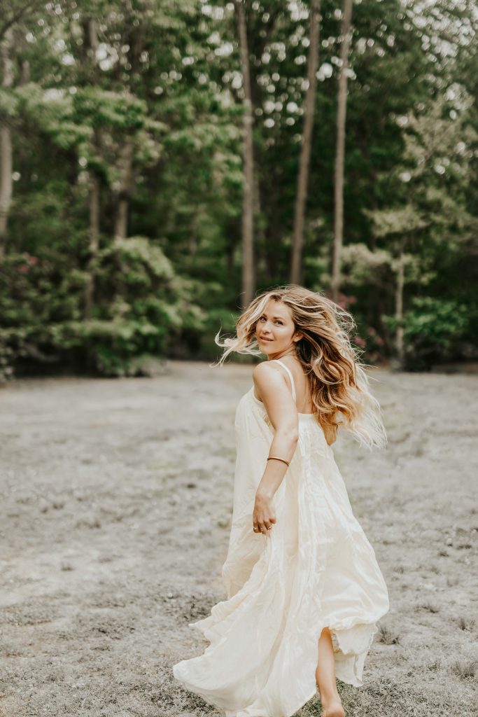 daria-magazzu-g7hXunZoTNs-unsplash | Elope to Australia woman running and turning, cream dress, sand and trees
