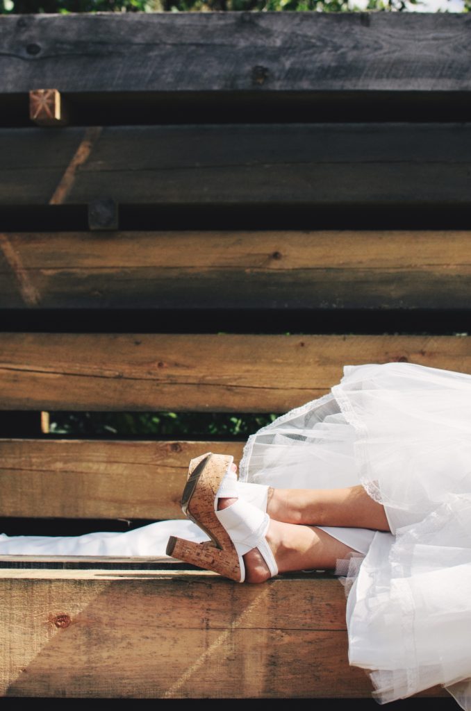 scott-webb-BRl211-kaXo-unsplash | Elope to Australia woman, bridal gown, feet up, white high heels